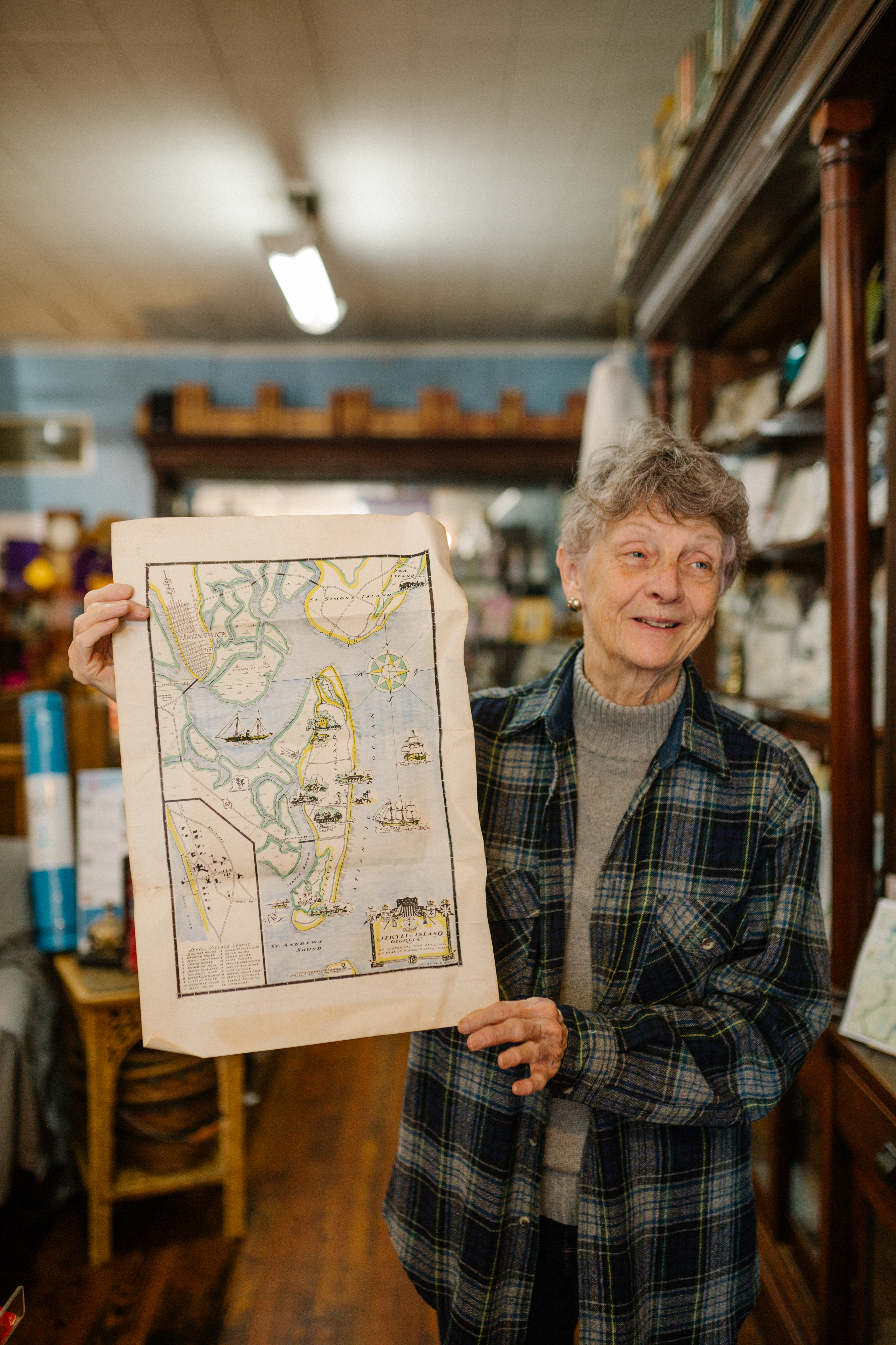 Shop keeper of Horton's Bookstore holding a map.